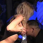 Busty blonde stripper rubs her titties in a customer's face