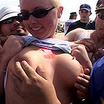 Blonde beachbabe flashing her titties